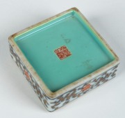A Chinese porcelain lidded box of square form with hand-painted landscape scene, 20th century, iron red seal mark to base, 5cm high, 6cm wide, 6cm deep - 4