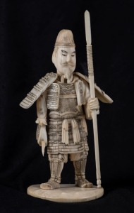 A Japanese carved ivory okimono warrior, Meiji period, ​​​​​​​15cm high