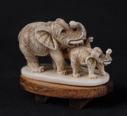 A Japanese carved ivory elephant group netsuke, on later wooden base, ​​​​​​​5cm wide - 2