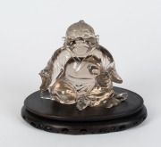A Chinese carved rock crystal statue on wooden base,&nbsp; 14cm high overall