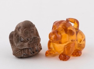 A Japanese carved amber dog netsuke; together with a carved boxwood monkey netsuke, Meiji period, 3.5cm and 4cm high