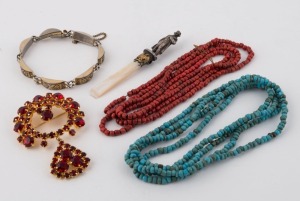 A costume jewellery red stone brooch, a silver finished bracelet, a Napoleon ornament, a Tibetan coral bead necklace and a turquoise bead necklace, (5 items), the necklaces 115cm long