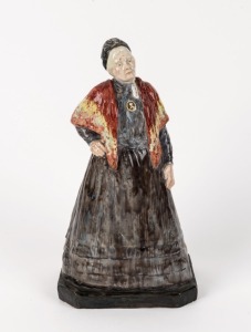 An English art pottery statue of a lady, early to mid 20th century, 26cm high
