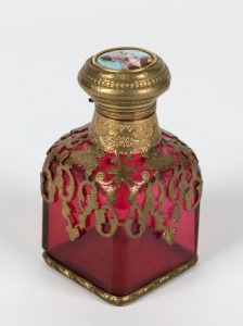 An antique French ruby glass scent bottle with gilt metal mounts and enamel portrait top, 19th century,  8.5cm high