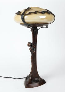 An Art Nouveau style figural bronze table lamp with yellow glass shade, late 20th century, ​​​​​​​59cm high