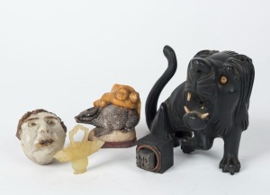 A Chinese carved wooden lion statue, a carved jade basket ornament, a carved stone figural group, a metal seal, and a pottery whistle, (5 items), ​​​​​​​the largest 11cm high