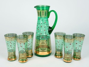 A vintage green glass lemonade set with enamel and gilt decoration, circa 1950s, (7 items), the jug 31cm high