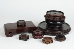 Nine assorted Chinese carved wooden stands, 19th/20th century, the largest 24cm diameter