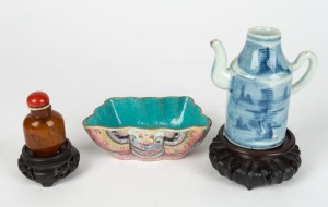 An antique Chinese porcelain dish, a Ming Dynasty blue and white porcelain water pourer, an amber opium bottle and two wooden stands, (5 items), the dish 14.5cm wide