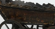 A Dutch folk art carved wood and iron toy cart, beautifully painted with ship portrait of the ZEEHOND (Sea Hound), dated 1781 and town scenes on the sides, 18th century, 30cm high, 39cm long, 18cm wide - 7