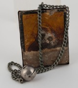 An early Russian silver icon, mounted on a chain with bell, 17th/18th century,the icon 8.5cm high, 32cm long overall - 2