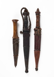 Three tribal daggers with leather sheaths, East African and Sudanese, ​​​​​​​the largest 33cm long