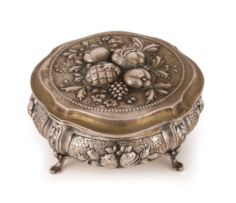 An antique German silver box with repousse fruit decoration and cabriole legs, remains of gilt wash finish still showing, 19th century, crown and crescent mark, stamped 800, 5.5cm high, 11.5cm wide, 270 grams