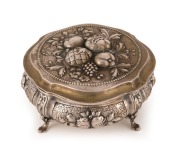 An antique German silver box with repousse fruit decoration and cabriole legs, remains of gilt wash finish still showing, 19th century, crown and crescent mark, stamped 800, 5.5cm high, 11.5cm wide, 270 grams