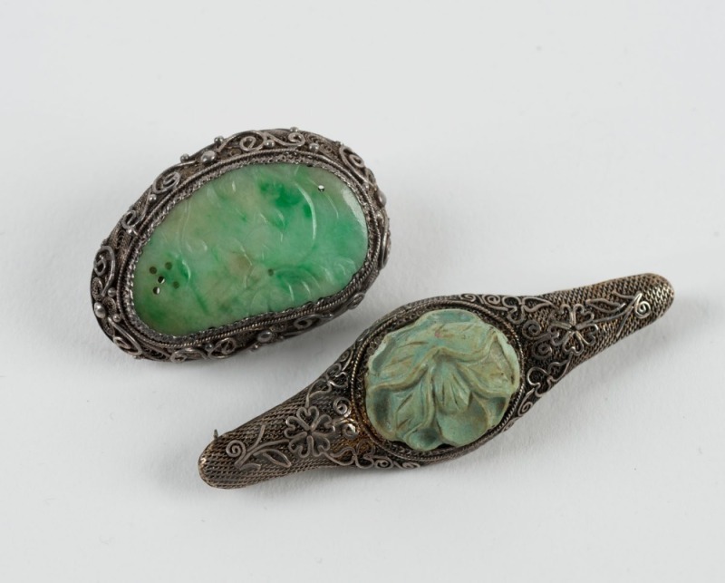 Two Chinese silver and jade brooches, early to mid 20th century, 5.5cm and 3.5cm wide