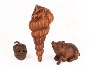 A Japanese carved boxwood skull Ojime bead, together with a carved boxwood shell ornament adorned with a frog, and a carved boxwood wild boar netsuke, 20th century, (3 items), the largest 8cm long