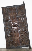 A Dogon granary door, carved wood and metal, Mali, West Africa, 150cm high, 74cm wide