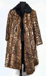 A lady's ocelot coat with black fur collar, poor condition.