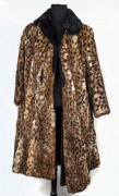 A lady's ocelot coat with black fur collar, poor condition.
