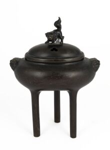 An antique Chinese bronze censer of oval form with three long cylindrical legs and lion mask decoration and finial, finely inlaid most likely in silver with seal mark to base, 19th century or earlier, 17cm high, 13cm wide