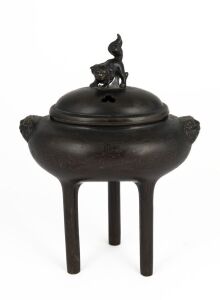 An antique Chinese bronze censer of oval form with three long cylindrical legs and lion mask decoration and finial, finely inlaid most likely in silver with seal mark to base, 19th century or earlier, 17cm high, 13cm wide 