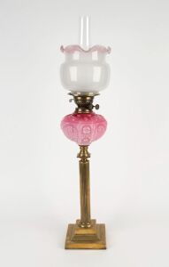 An antique banquet lamp with brass column base, pink glass font, double burner, (later shade) and chimney, 19th century, ​​​​​​​80cm high