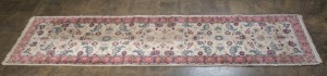 A Persian hand-knotted floral runner with pink and cream ground, remains of Hali Rug Gallery label verso, 333 x 80cm