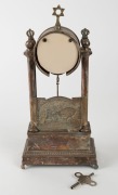 JUDAICA: Idox German mantel clock, surmounted by a star of David with Torah crown finials, and featuring a brass panel depicting a farmer with an ox tilling the soil, with the biblical verse (in Hebrew) "Work the land and you will be satisfied with bread" - 2