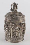 A fine Burmese silver box with repousse decoration and figural finial. 19th/20th century. Note the inclusion of winged angel and lion decoration. 15cm high, 334 grams - 4