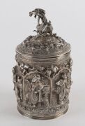 A fine Burmese silver box with repousse decoration and figural finial. 19th/20th century. Note the inclusion of winged angel and lion decoration. 15cm high, 334 grams - 5