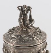 A fine Burmese silver box with repousse decoration and figural finial. 19th/20th century. Note the inclusion of winged angel and lion decoration. 15cm high, 334 grams - 6