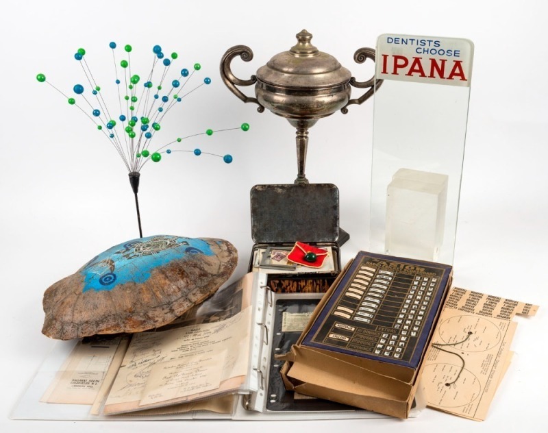 "ADELAIDE HUNT CLUB" silver plated trophy, carved malachite egg ornament, "The Astor Radio Cricket Scoreboard (incomplete), bauble table ornament and glass advertising panel "DENTISTS CHOOSE IPANA", and a painted antique turtle shell, 20th century, (6 ite