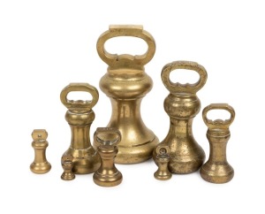 Set of eight antique brass bell weights, the largest 14lb, (22cm high)