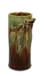 REMUED cylindrical pottery vase with applied gumnuts and leaves, glazed in green and brown, incised "Remued, Hand Made 145/9M", 24cm high