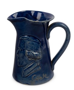 REMUED "COOK, SOUVENIR OF MELBOURNE" blue glazed pottery jug, circa 1934. incised "Remued", 13cm high
