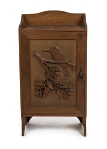 An Australian kauri pine folk art cabinet carved with kookaburra and gum branch, early 20th century,  interior fitted with shelves 85cm high x 42 cm wide x 20cm deep