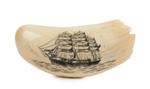 A scrimshaw whale's tooth engraved with a whaling scene, 13cm high