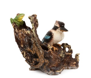 An Australian ceramic animal group on log sculpture, incised signature and date (illegible), 31cm high, 40cm wide