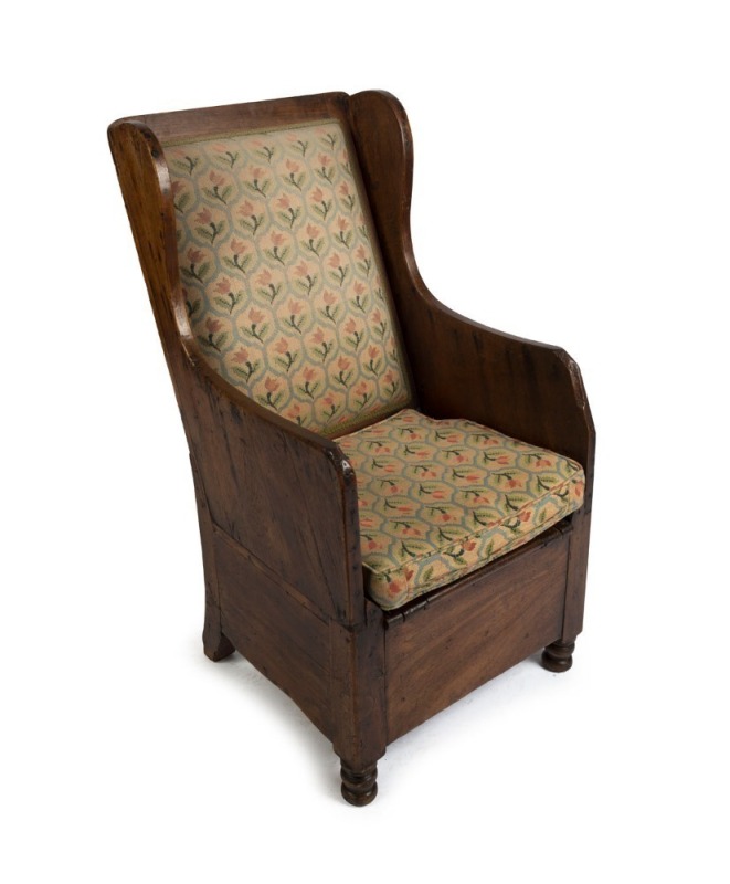 An early primitive Australian winged armchair/commode in the Georgian style, cedar and eucalyptus, Tasmanian origin, circa 1830s, purchased from Evandale antiques in 1977, 109cm high, 57cm across the arms. Illustrated in "Nineteenth Century Australian Fur