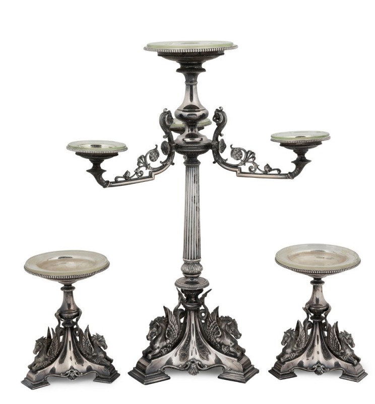 CORIO VILLA: Stunning antique English silver plated centrepiece with garnitures, adorned with Pegasus and rams head decoration, 19th century. With original hand-blown glass drip pans. This three piece suite formed part of the original furnishings of the f