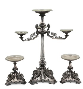 CORIO VILLA: Stunning antique English silver plated centrepiece with garnitures, adorned with Pegasus and rams head decoration, 19th century. With original hand-blown glass drip pans. This three piece suite formed part of the original furnishings of the famed mansion in Geelong. 51cm high, 39cm wide