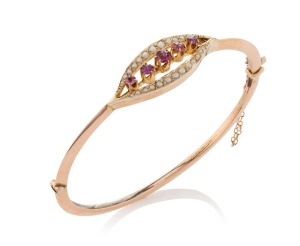 An antique 9ct rose gold bangle, set with seed pearls and pink stones, early 20th century, 6.5cm wide, 7 grams total