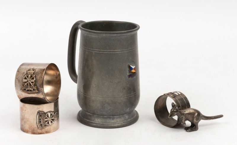 H.M.A.S. AUSTRALIA pair of silver plated napkin rings, together with a V.M. MANUNDA silver plated kangaroo napkin ring (the Manunda became a hospital ship in 1940), as well as an S.S. CANBERRA pewter tankard, (4 items, the tankard 13cm high