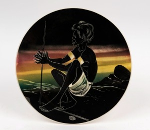 THE LITTLE POTTERY circular wall plaque of an Aborigine lighting a fire, stamped "The Little Pottery, Australia", ​​​​​​​29.5cm diameter