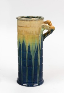 REMUED blue glazed cylindrical pottery vase with applied branch handle, incised "Remued 145/9", 22.5cm high