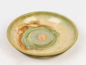 REMUED pottery bowl with applied branch handle, glazed in green and brown, incised "REMUED 1991 LH", 27.5cm diameter