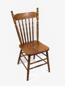 A Colonial Kangaroo back cottage chair, registration stamp Rd 252, with kauri pine saddle seat and ring turned ash legs and cross stretcher, circa 1910 95cm high, 39cm across the seat.