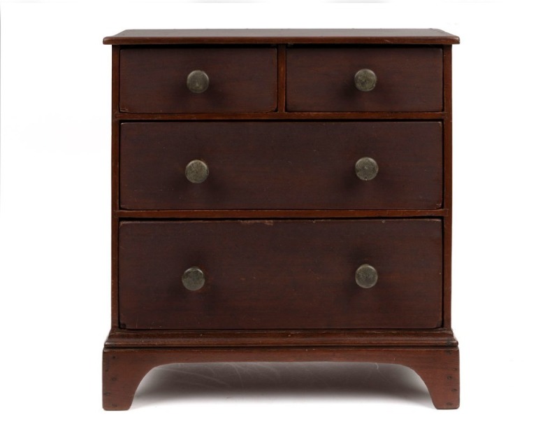 A Colonial miniature chest of four drawers, the ogee moulded base above bracket feet, cedar with pine secondary timbers, later brass drawer knobs, circa 1890 43cm high, 41cm wide, 21cm deep