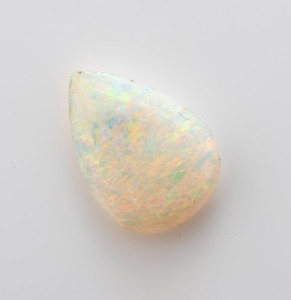 A solid white opal polished to an almond shape, ​​​​​​​11mm