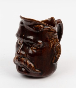 BENDIGO pottery face jug with Rockingham glaze, 19th century, ​​​​​​​14cm high